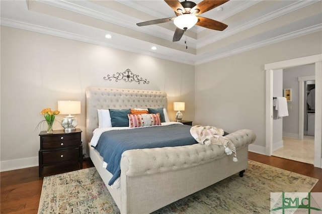 bedroom with crown molding, wood finished floors, a raised ceiling, baseboards, and recessed lighting