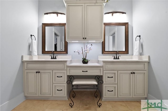 bathroom featuring double vanity, tile patterned flooring, and baseboards