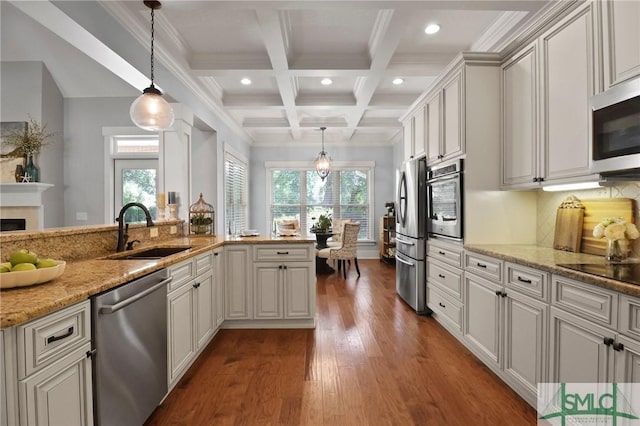 kitchen featuring a sink, appliances with stainless steel finishes, beam ceiling, healthy amount of natural light, and recessed lighting