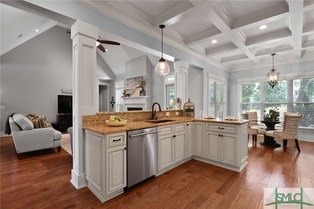 kitchen with stainless steel dishwasher, a sink, open floor plan, light stone counters, and beamed ceiling