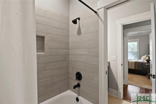 bathroom with shower / tub combo with curtain and wood finished floors