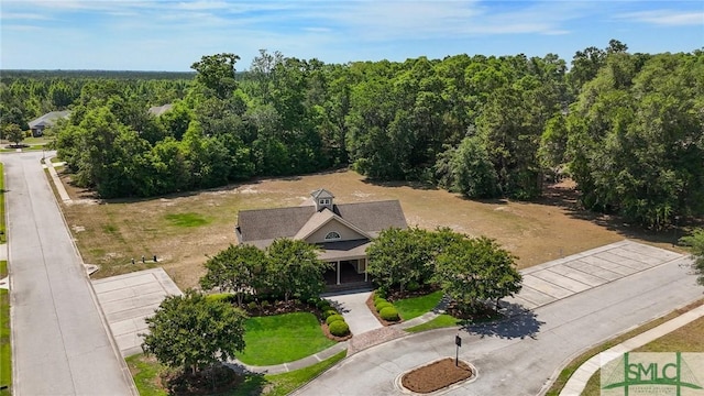 view of subject property with a heavily wooded area