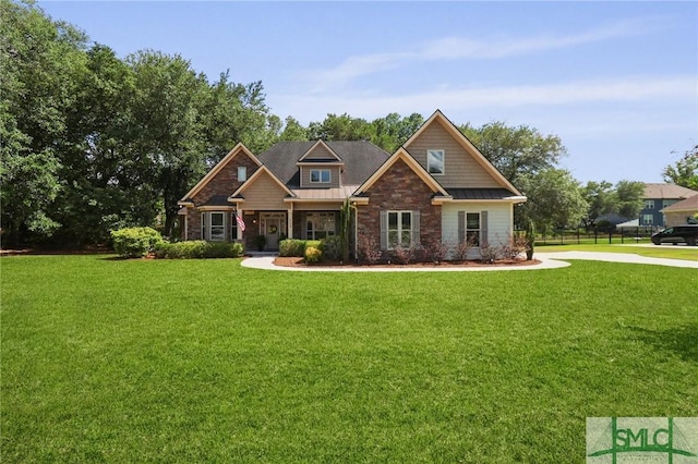 craftsman inspired home with stone siding, a front lawn, a standing seam roof, and metal roof