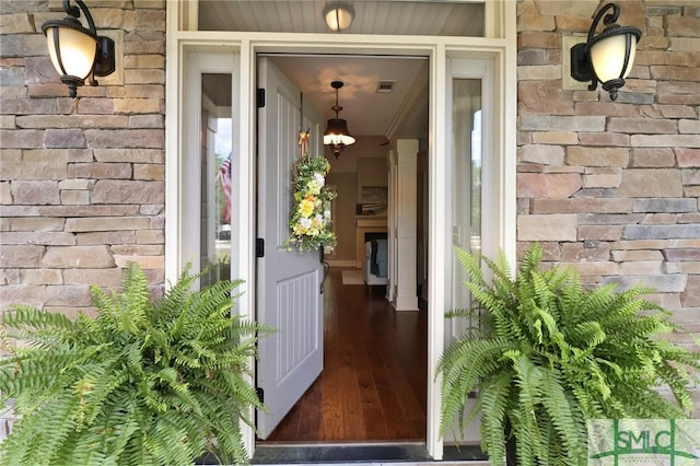 doorway to property with brick siding