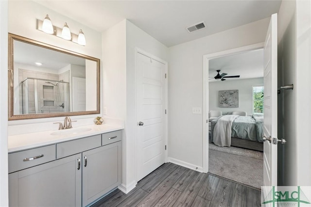 89 Evan Wade Ct NE, Ludowici, GA 31316 - ensuite bathroom with a stall shower, wood finished floors, vanity, a ceiling fan, and baseboards
