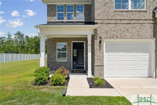 89 Evan Wade Ct NE, Ludowici, GA 31316 - doorway to property featuring brick siding, a garage, and concrete driveway