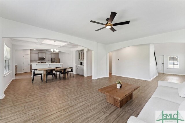 89 Evan Wade Ct NE, Ludowici, GA 31316 - living area featuring arched walkways, light wood-style floors, ceiling fan, and baseboards