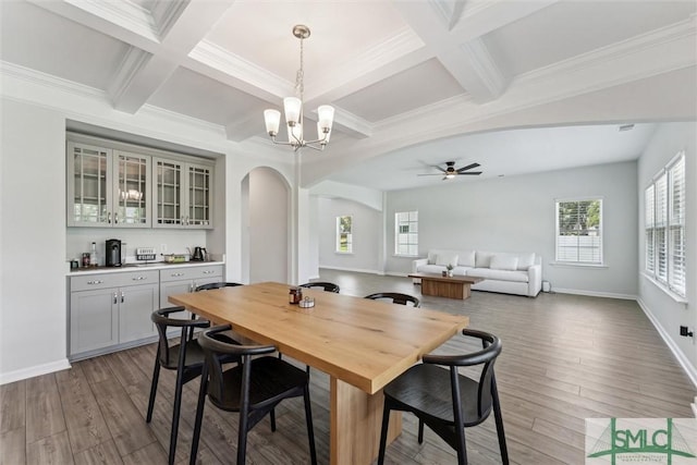 89 Evan Wade Ct NE, Ludowici, GA 31316 - dining room with arched walkways, coffered ceiling, beam ceiling, a chandelier, and wood finished floors