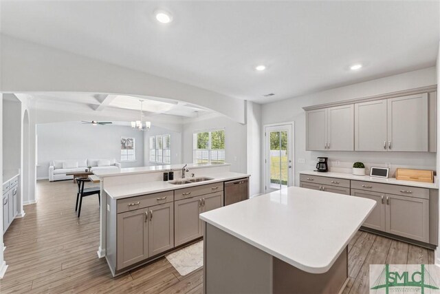 89 Evan Wade Ct NE, Ludowici, GA 31316 - kitchen with gray cabinetry, a kitchen island with sink, a sink, arched walkways, and stainless steel dishwasher