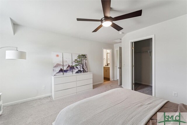 89 Evan Wade Ct NE, Ludowici, GA 31316 - carpeted bedroom with baseboards, connected bathroom, a walk in closet, a ceiling fan, and lofted ceiling
