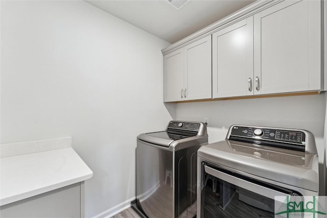 89 Evan Wade Ct NE, Ludowici, GA 31316 - laundry room with cabinet space, washing machine and clothes dryer, and baseboards
