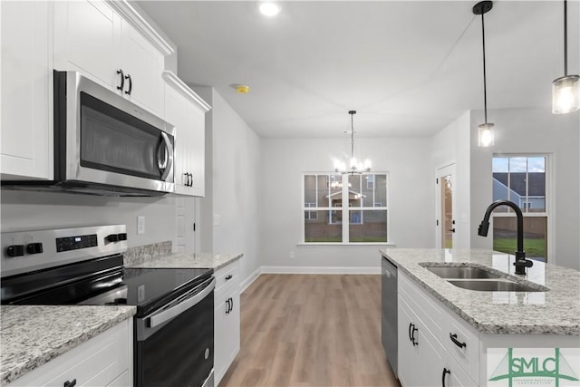 333 Crosswinds Dr, Rincon, GA 31326 - kitchen with appliances with stainless steel finishes, a sink, light wood-type flooring, a chandelier, and white cabinets