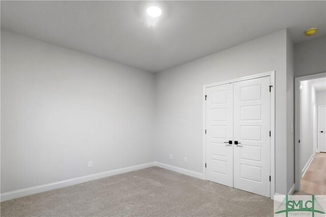 333 Crosswinds Dr, Rincon, GA 31326 - unfurnished bedroom with baseboards, a closet, and carpet flooring