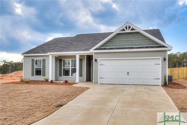 288 Timberlake Dr, Guyton, GA 31312 - view of front of house with driveway, an attached garage, fence, and central air condition unit