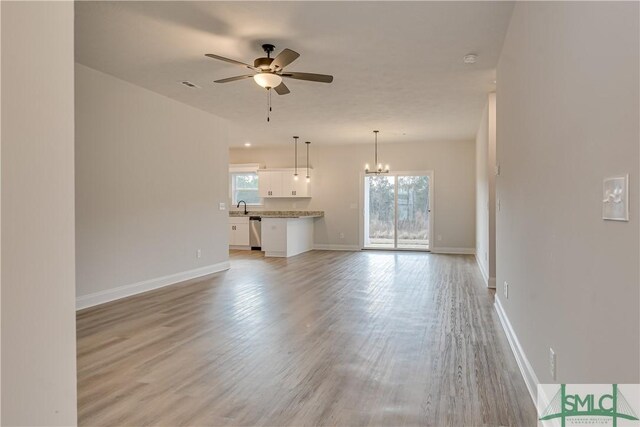 288 Timberlake Dr, Guyton, GA 31312 - unfurnished living room featuring plenty of natural light, ceiling fan, a sink, and light wood-type flooring