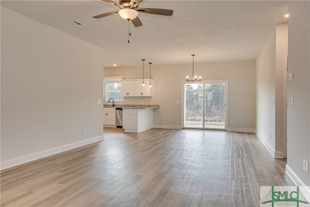 288 Timberlake Dr, Guyton, GA 31312 - unfurnished living room with ceiling fan, a sink, light wood-type flooring, a chandelier, and baseboards