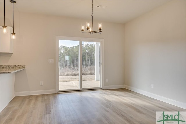 288 Timberlake Dr, Guyton, GA 31312 - unfurnished dining area with light wood finished floors, a chandelier, and baseboards