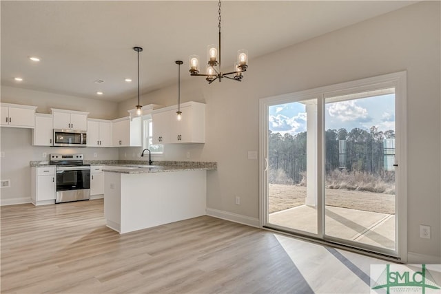 288 Timberlake Dr, Guyton, GA 31312 - kitchen with stainless steel appliances, a sink, light wood-style flooring, baseboards, and recessed lighting