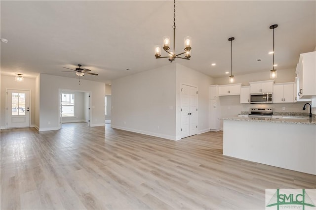 288 Timberlake Dr, Guyton, GA 31312 - kitchen featuring appliances with stainless steel finishes, ceiling fan, open floor plan, white cabinets, and light wood-type flooring