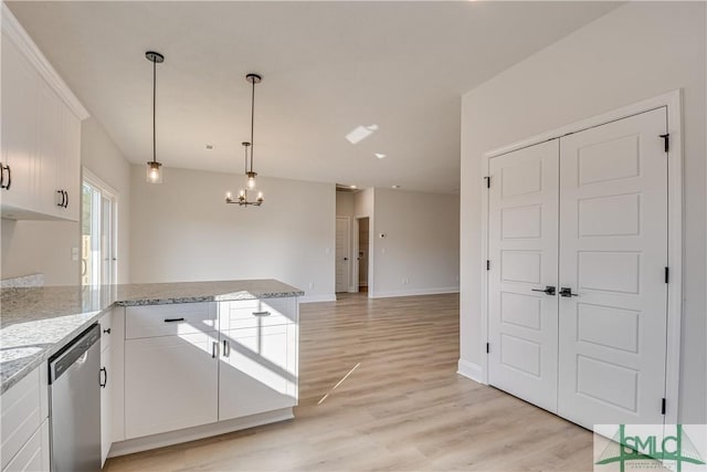 288 Timberlake Dr, Guyton, GA 31312 - kitchen with stainless steel dishwasher, white cabinets, a chandelier, a peninsula, and light wood-type flooring