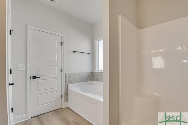 288 Timberlake Dr, Guyton, GA 31312 - bathroom featuring a garden tub and wood finished floors