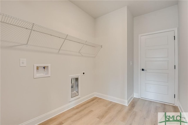 288 Timberlake Dr, Guyton, GA 31312 - washroom with hookup for an electric dryer, washer hookup, light wood finished floors, and baseboards