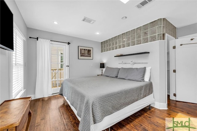 bedroom with hardwood / wood-style flooring, recessed lighting, and access to outside