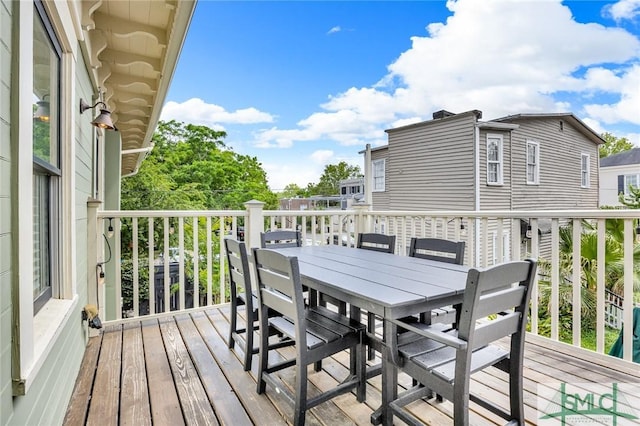 wooden terrace with outdoor dining space
