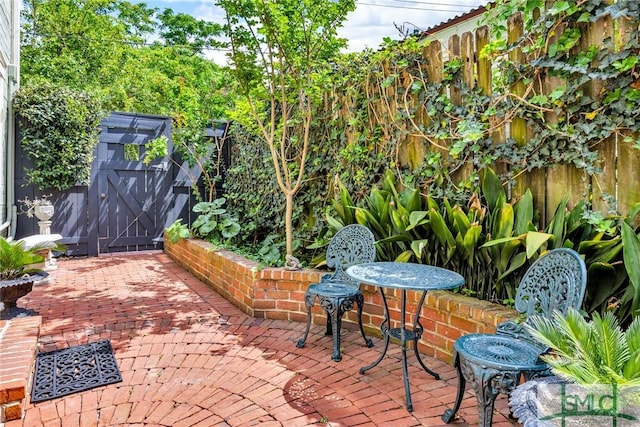 view of patio featuring fence