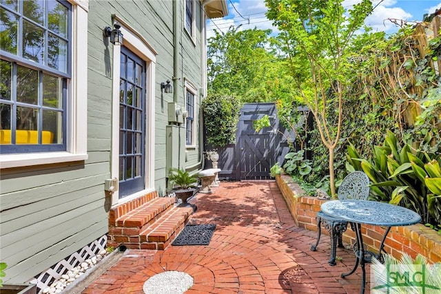 view of patio / terrace featuring a storage shed, an outbuilding, and entry steps