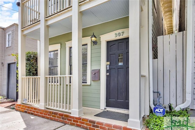 view of exterior entry featuring covered porch