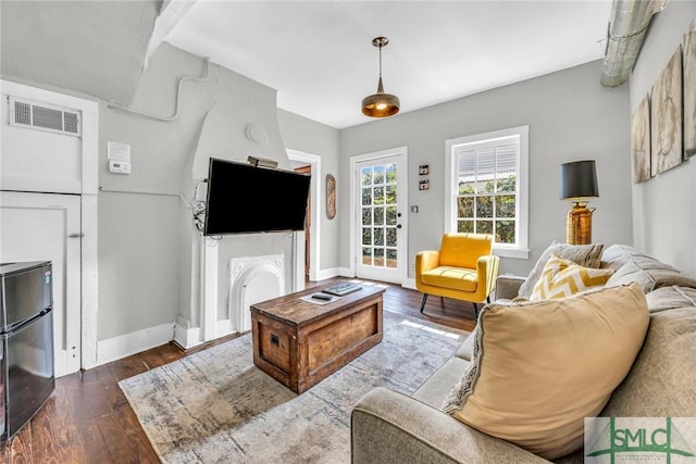 living area featuring dark wood finished floors and baseboards