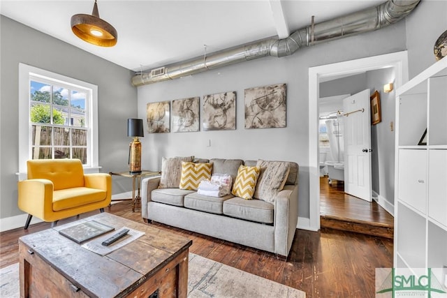 living area featuring hardwood / wood-style flooring and baseboards
