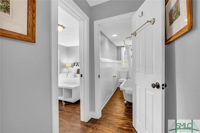 corridor with dark wood finished floors and recessed lighting