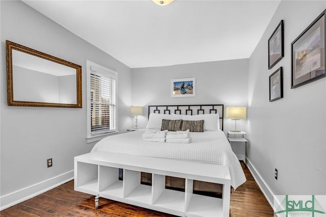 bedroom featuring baseboards and wood finished floors