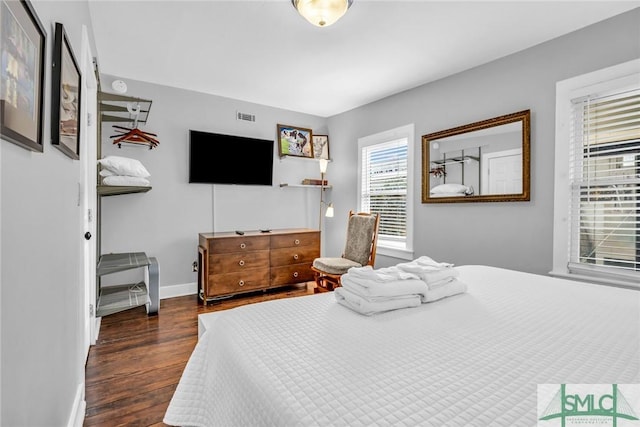 bedroom with wood finished floors and baseboards