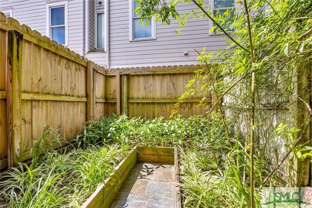 view of yard with fence and a vegetable garden