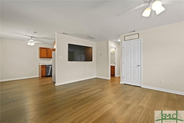 unfurnished living room with a ceiling fan, dark wood finished floors, and baseboards