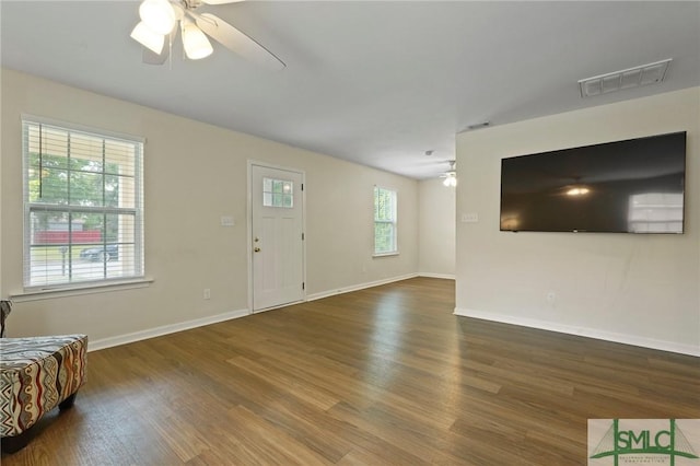 living room featuring a ceiling fan, wood finished floors, and baseboards