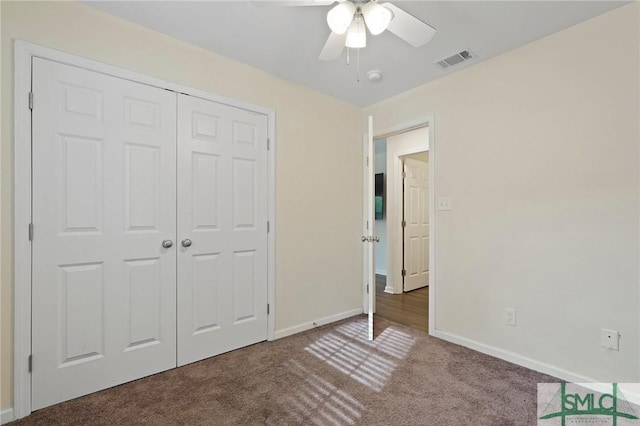 unfurnished bedroom with carpet flooring, baseboards, a closet, and a ceiling fan