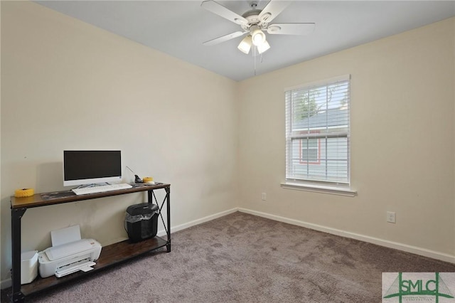 carpeted home office with a ceiling fan and baseboards