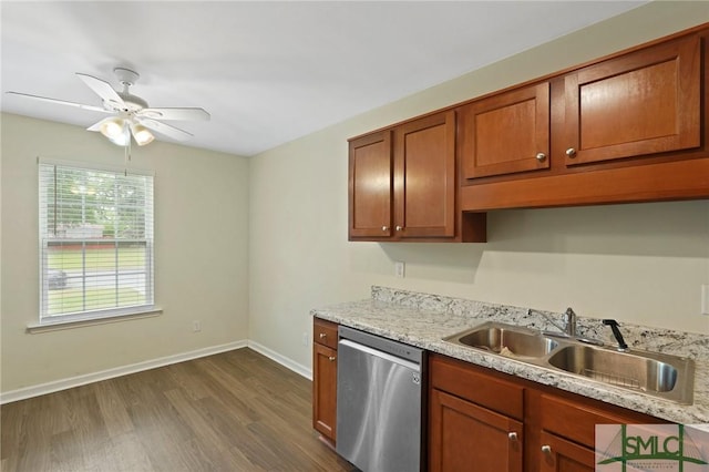 kitchen featuring dishwasher, a sink, dark wood-style flooring, a ceiling fan, and baseboards