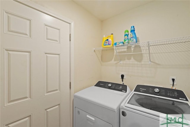 clothes washing area featuring separate washer and dryer