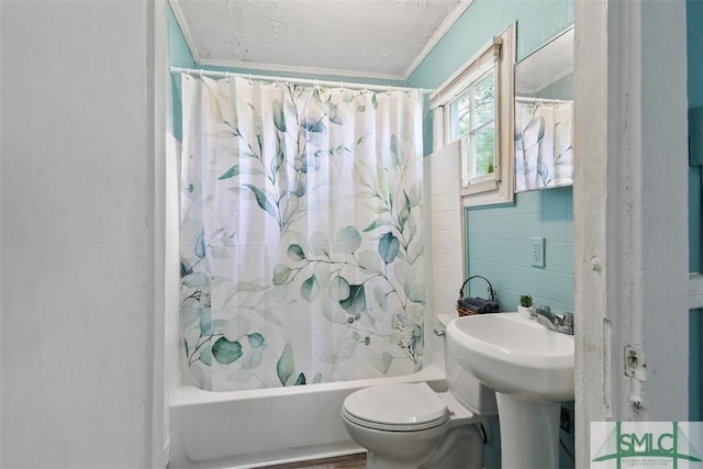 full bathroom with a textured ceiling, toilet, shower / bath combination with curtain, and tile walls