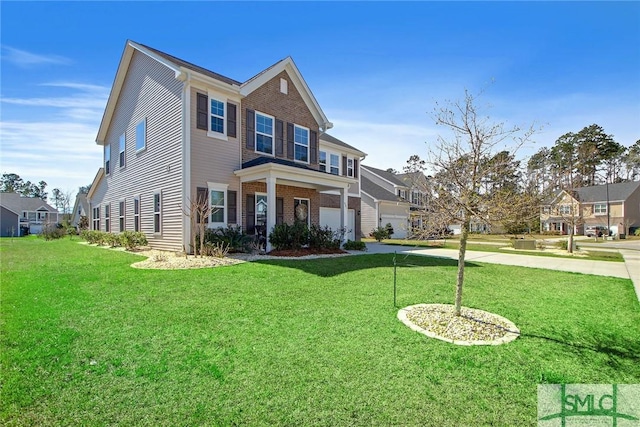 901 Garden Hills Loop, Richmond Hill, GA 31324 - view of front of house featuring driveway, a front lawn, brick siding, and a garage
