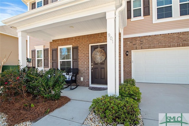 901 Garden Hills Loop, Richmond Hill, GA 31324 - property entrance featuring brick siding, covered porch, and driveway