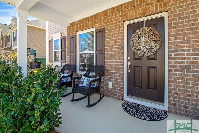 901 Garden Hills Loop, Richmond Hill, GA 31324 - doorway to property featuring a porch and brick siding