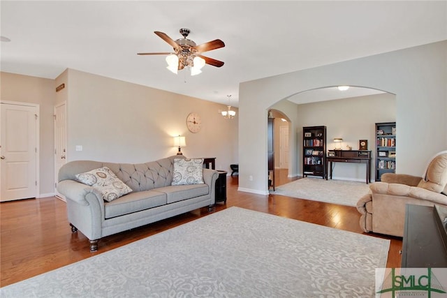 901 Garden Hills Loop, Richmond Hill, GA 31324 - living room with arched walkways, ceiling fan, wood finished floors, and baseboards