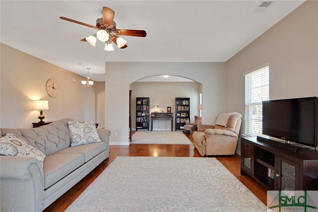 901 Garden Hills Loop, Richmond Hill, GA 31324 - living room featuring arched walkways, wood finished floors, ceiling fan, and baseboards