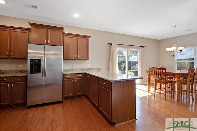 901 Garden Hills Loop, Richmond Hill, GA 31324 - kitchen featuring stainless steel fridge, a peninsula, wood finished floors, plenty of natural light, and recessed lighting
